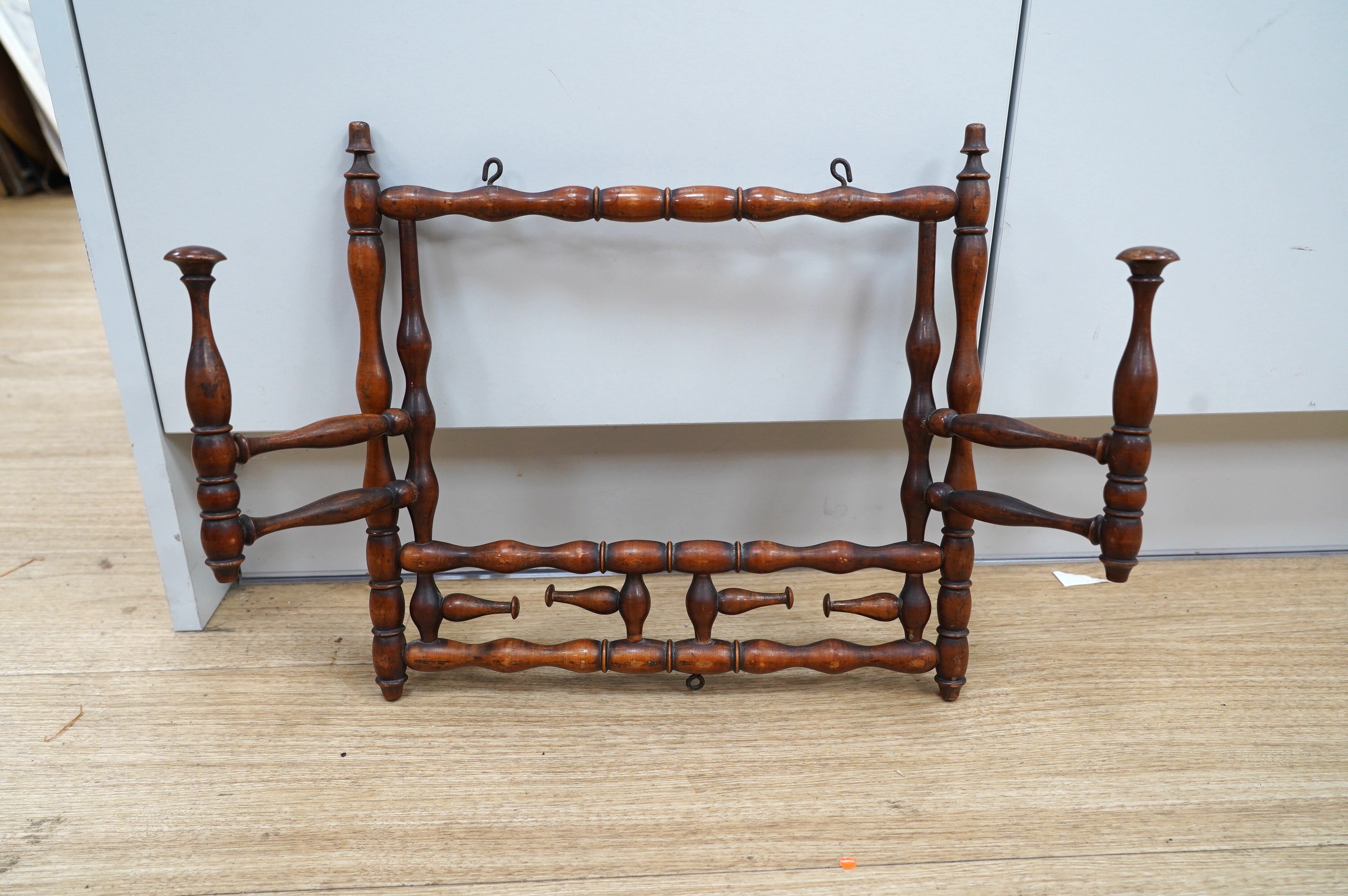 A late 19th century turned wood folding wig stand, 35cm wide. Condition - good